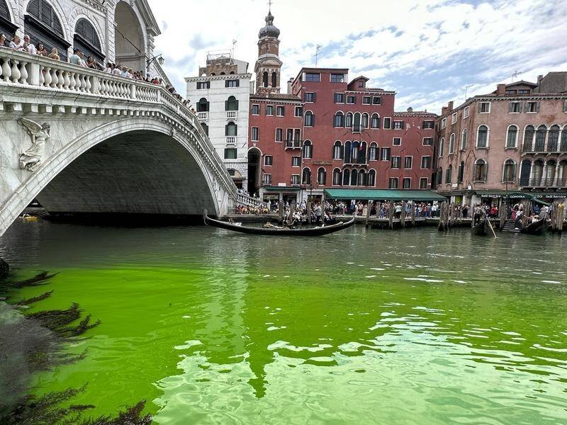 Speculation is rife as to what might have caused the water around the Rialto Bridge to turn green. (AP)