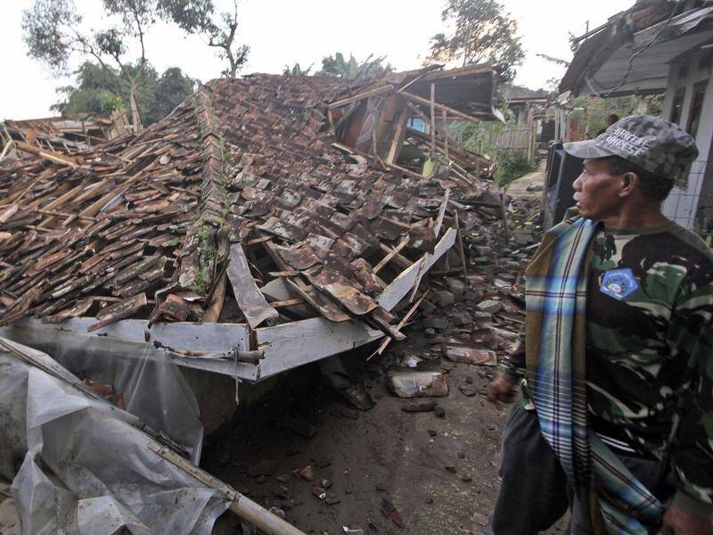 Indonesian authorities say more than 2200 houses were damaged following a quake and aftershocks. (AP PHOTO)
