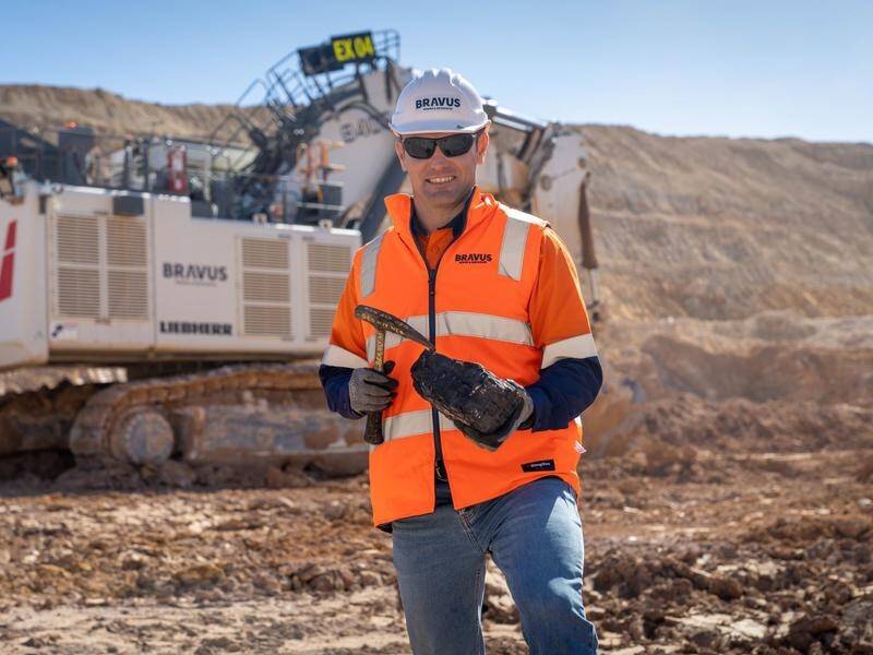 David Boshoff, CEO of Bravus Mining, holds a lump of coal at the Carmichael mine project.