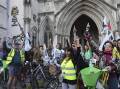 Supporters of Julian Assange have ended their bike demo at the Royal Courts of Justice in London. (AP PHOTO)
