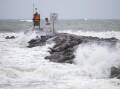 Five people were rescued from a boat in choppy seas as Tropical Storm Ophelia hit North Carolina. (AP PHOTO)