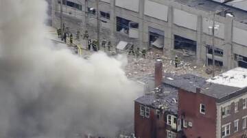 Police are investigating the cause of a fatal blast that destroyed one building and damaged another. (AP PHOTO)