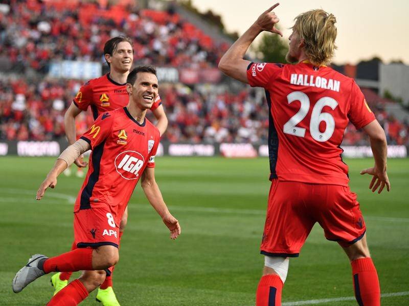 Adelaide United celebrates Ben Halloran's second goal against Brisbane in round six.
