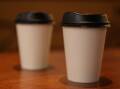Single-use, non-compostable coffee cups are now banned in WA but compostable cups are still allowed. (Diego Fedele/AAP PHOTOS)
