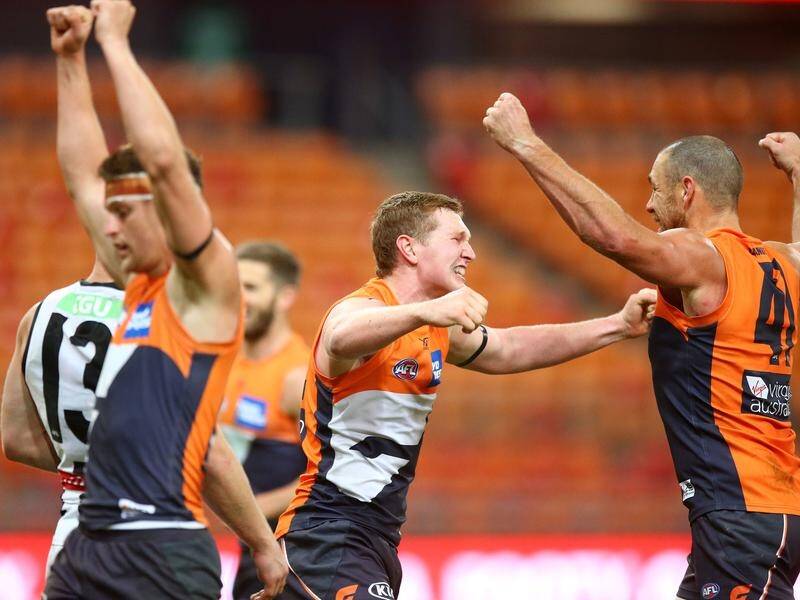 Tom Green and Shane Mumford celebrate the Giants' win over Collingwood.