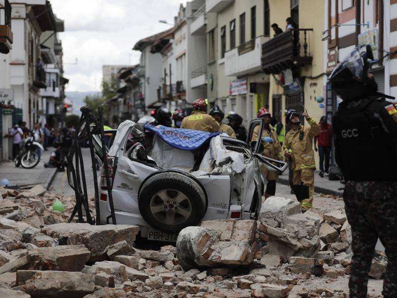One of the quake victims was a passenger in a vehicle crushed by rubble from a house in Cuenca. (AP PHOTO)