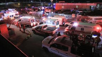 Ambulances and firefighters arrived at the facility in Ciudad Juarez following the fire. (EPA PHOTO)