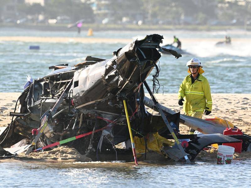 Four people were killed when two helicopters collided in mid-air near Sea World on the Gold Coast. (Dave Hunt/AAP PHOTOS)