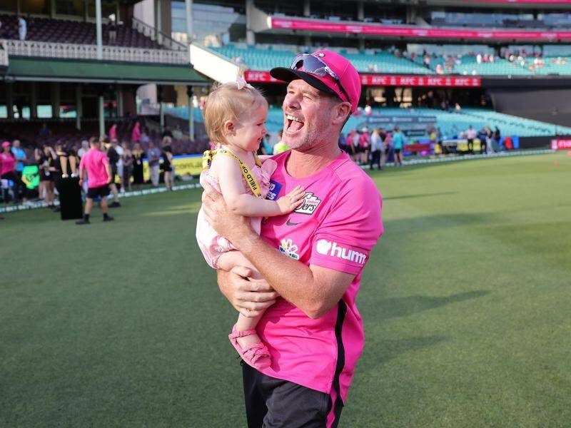 Sixers' star Dan Christian hugs daughter Harper after a presentation at his final match at the SCG. (Mark Evans/AAP PHOTOS)