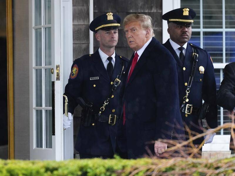A video taken when Donald Trump attended the wake of a police officer has drawn criticism. (AP PHOTO)