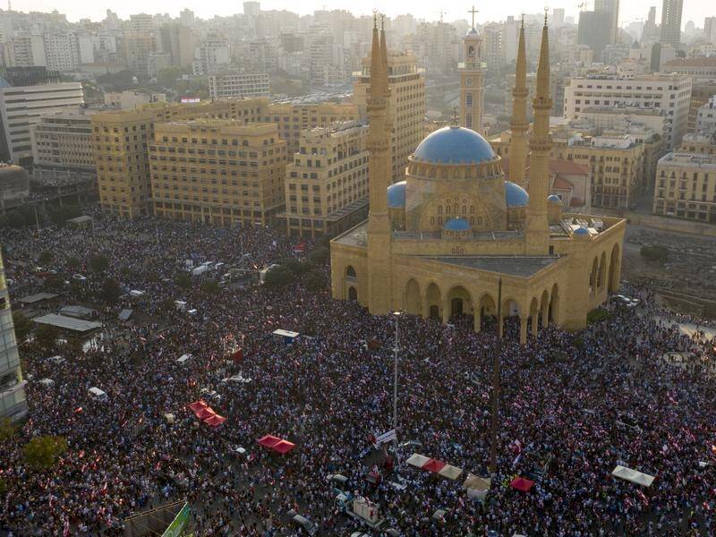 Hundreds of thousands of Lebanese protesters have flooded major cities and towns including Beirut.
