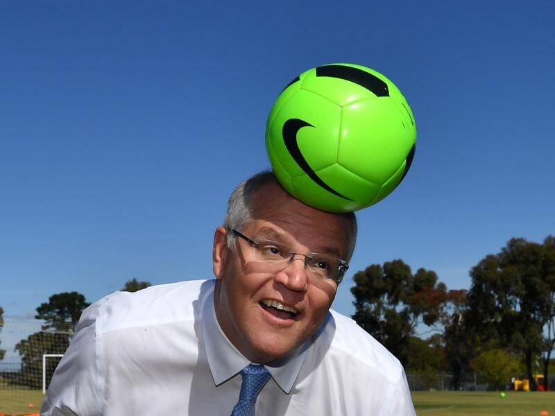 Prime Minister Scott Morrison heads a soccer ball at near Adelaide on Tuesday.
