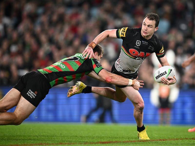 Dylan Edwards of the Panthers is tackled by Souths' Jed Cartwright during the NRL preliminary final. (Dan Himbrechts/AAP PHOTOS)