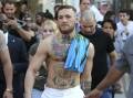 Conor McGregor says he is lucky to be alive after being struck by a motorist while on his bike. (AP PHOTO)
