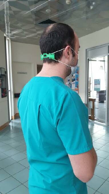DEMONSTRATION: Dr Bob Vickers models the 3D-printed band attached to his face mask. (PHOTO SUPPLIED)
