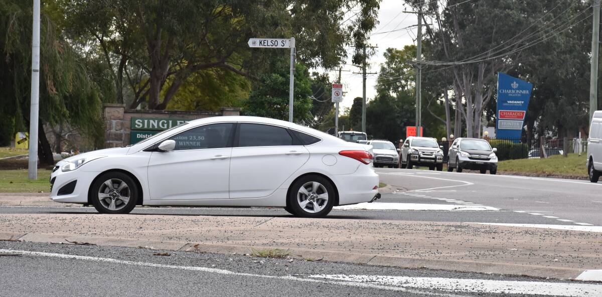 DETOUR: A driver is pictured taking a detour on Kelso Street at 11.40am less than half an hour after the two vehicle crash took place. 