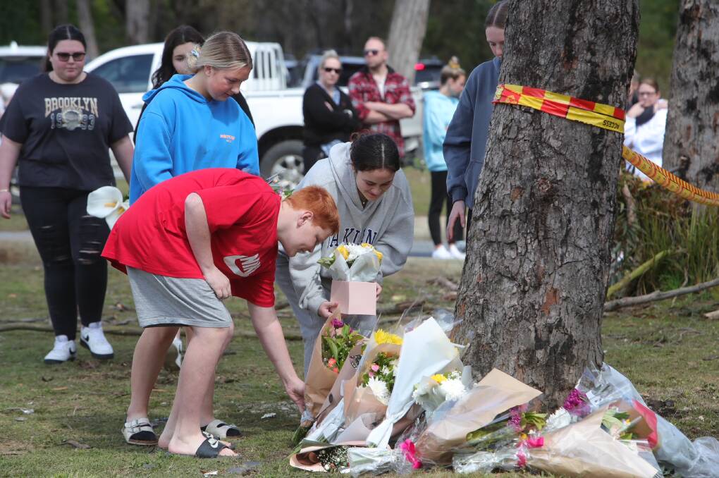 Grieving community members, most of them teenagers themselves, have been arriving at the scene of the crash to lay flowers and comfort one another. Picture by Sylvia Liber
