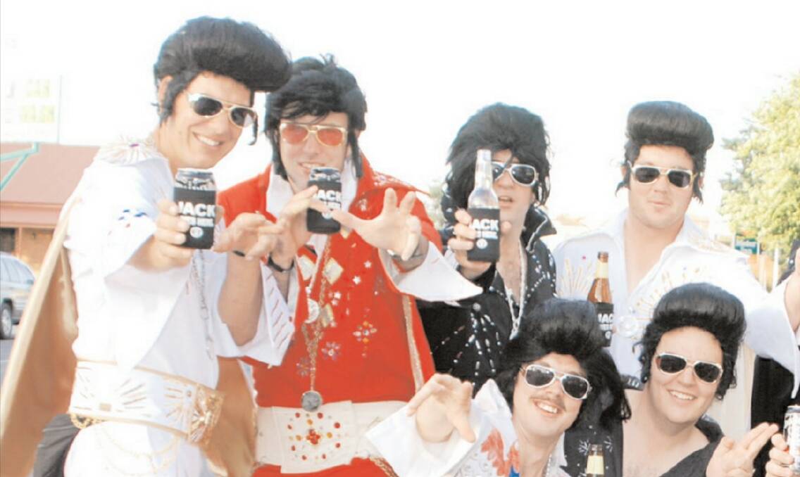 Wayne Osborne and Scott Morrissey (both left) in 2007 with their fellow rugby mates, who would become local celebrities each year during the Parkes Elvis Festival.