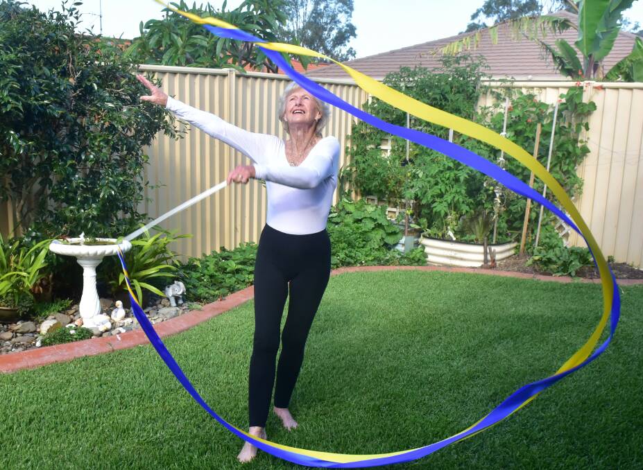 Doreen Rayward Wilson, 90, of Taree, NSW, practicing her gymnastics in her back yard. Picture by Julie Slavin