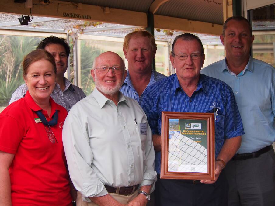 PRIDE: Showing off the Wingen Tidy Towns award is Upper Hunter Shire councillor Wayne Bedggood, Cr Maurice Collison and mayor Michael Johnsen (front) Heather Ranclaud, Cr Ron Campbell and John Gallen.  